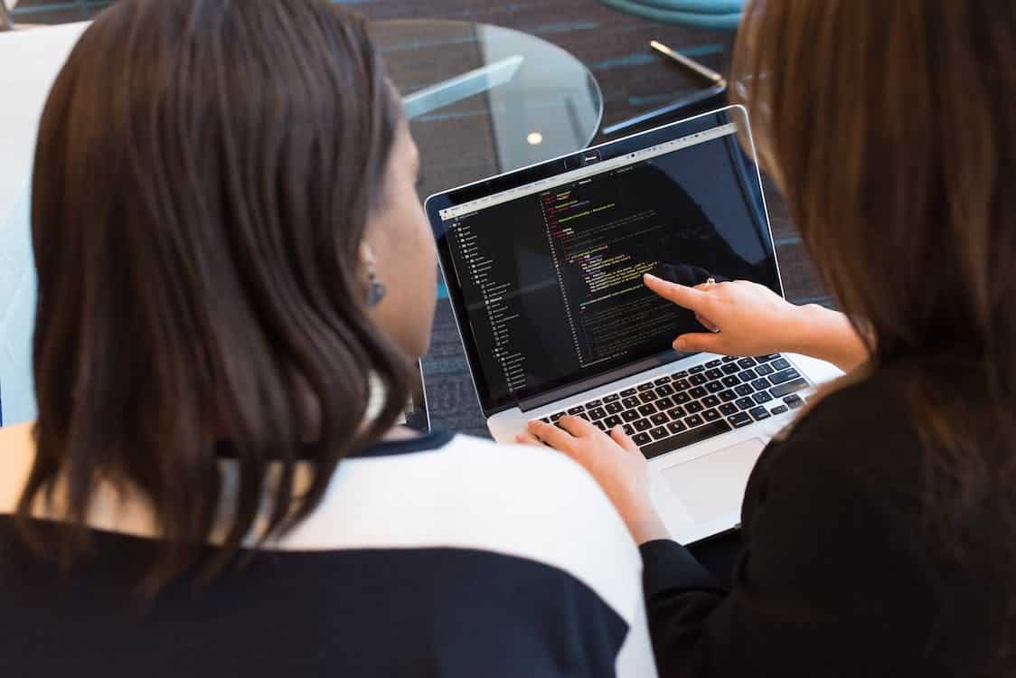 Free Two Women Looking at the Code at Laptop Stock Photo